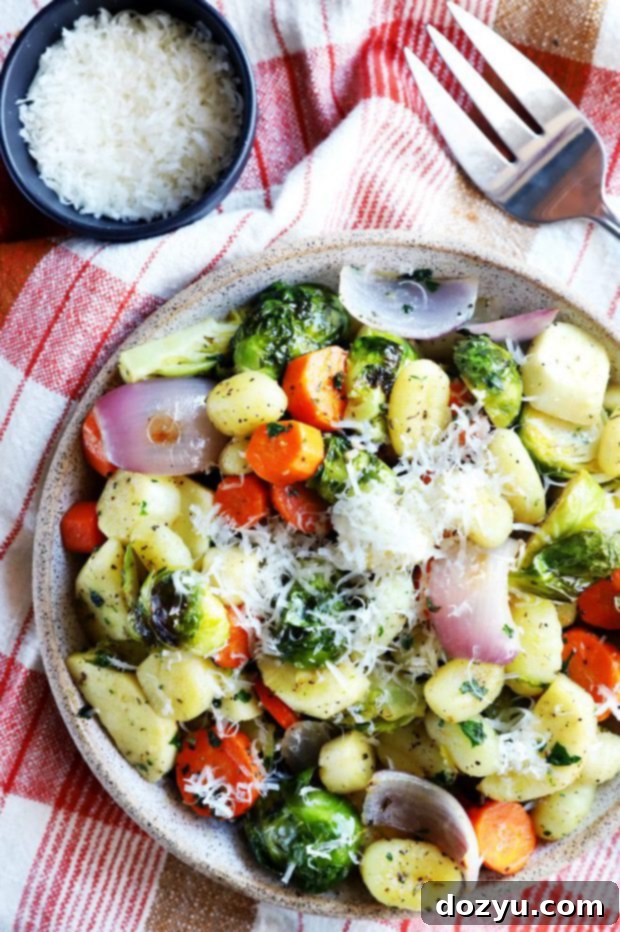Delicious sheet pan gnocchi with roasted winter vegetables on a baking sheet, ready to be served.