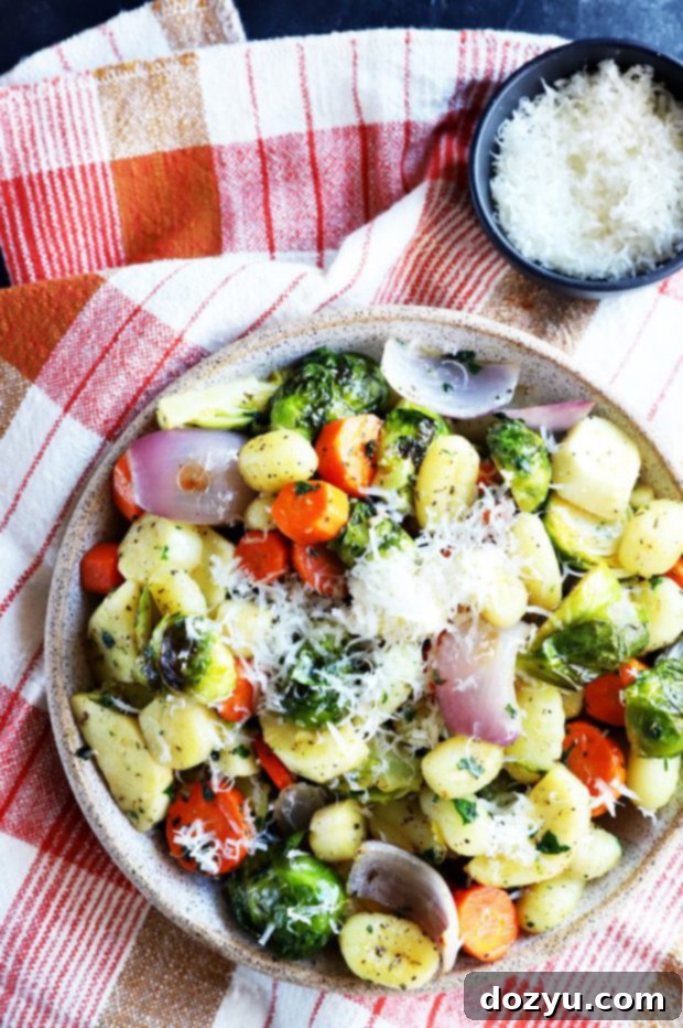 Overhead shot of a beautifully prepared sheet pan gnocchi with winter vegetables, showcasing its rustic appeal.