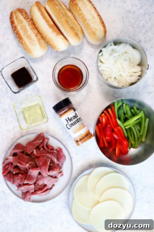 A vibrant selection of ingredients for Instant Pot Philly Cheesesteaks, including thinly sliced beef, colorful bell peppers, and Head Country seasoning.