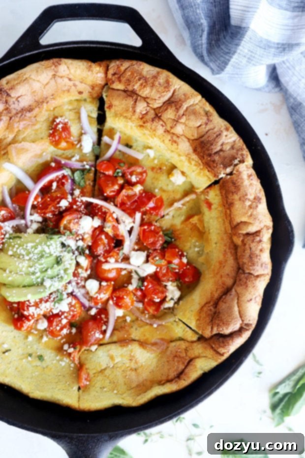 Savory Dutch Baby Bake 2 Slices of fluffy savory Dutch Baby pancake topped with fresh ingredients in a cast iron skillet.