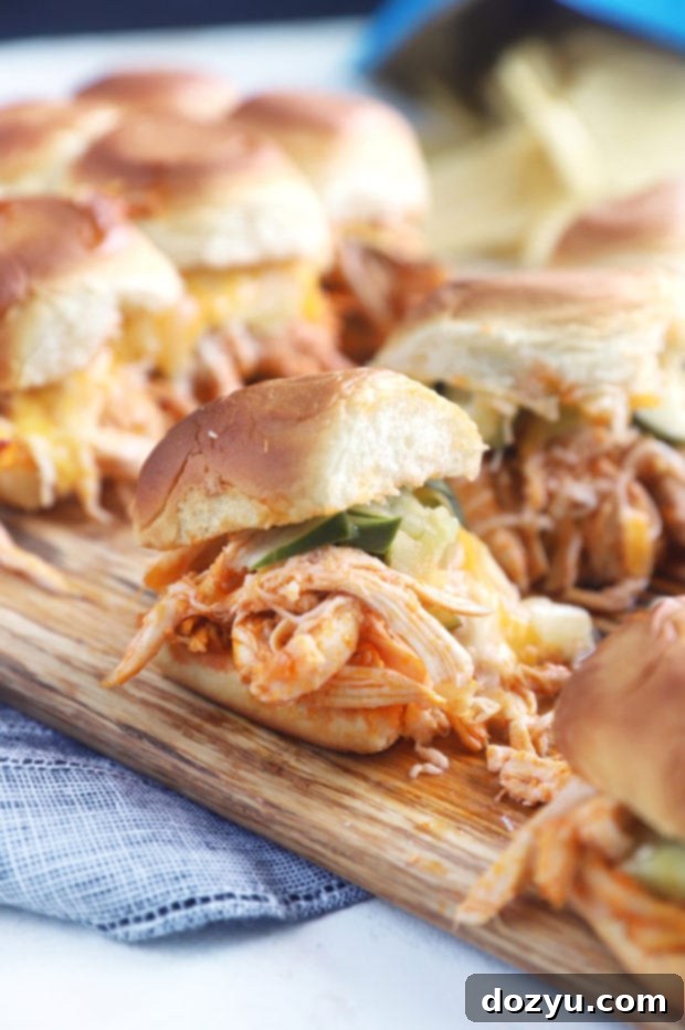Nashville Hot Chicken Sliders arranged on a serving board with a side of pickles