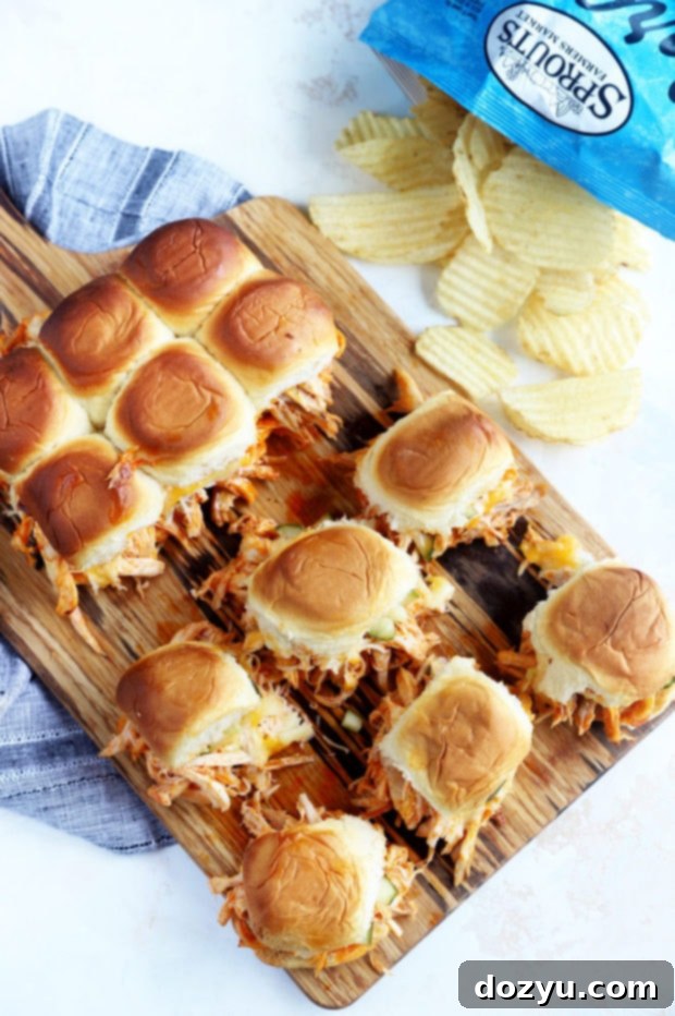 Pickle Brined Hot Chicken Sliders served on a wooden board with potato chips