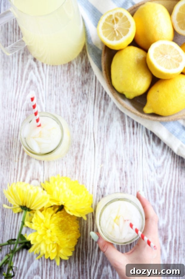 Close-up shot of two glasses of vodka lemonade on a wooden surface