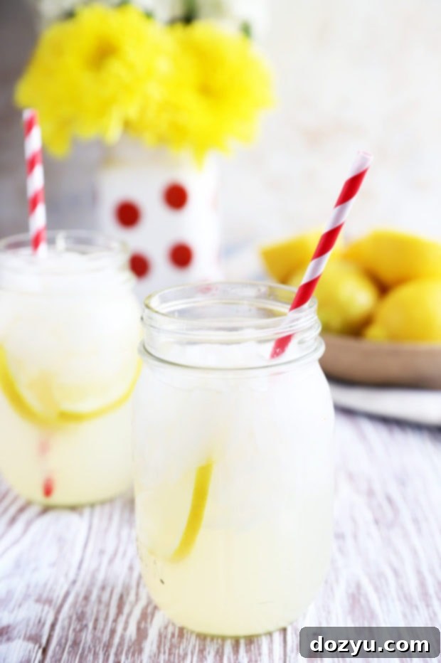 Three mason jars filled with homemade vodka lemonade and lemon slices