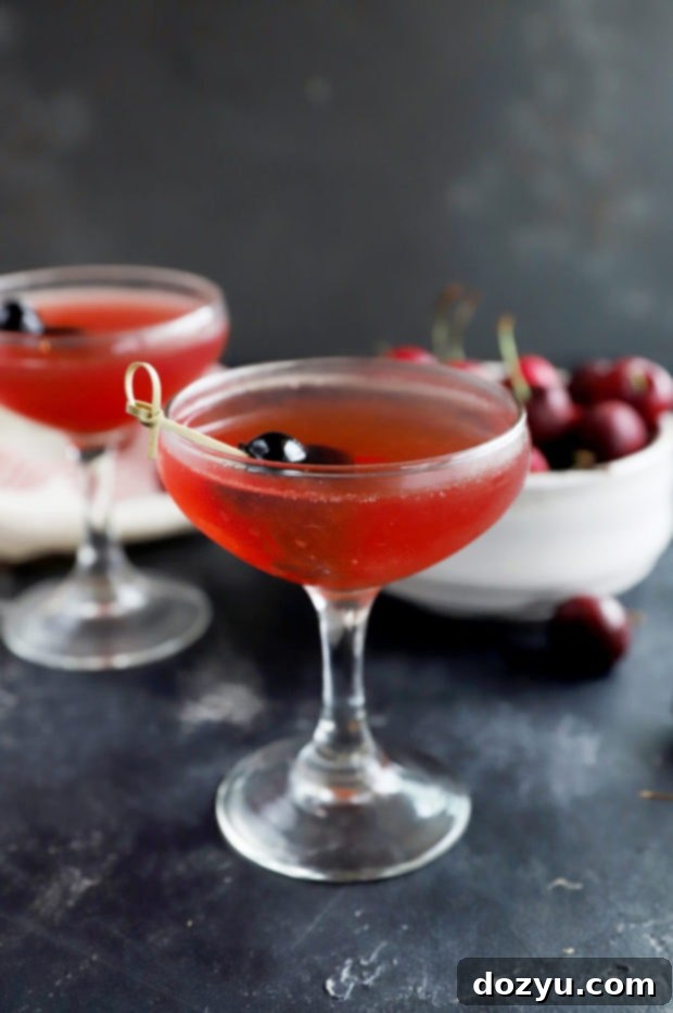 Photo of cherry cocktail in coupe glasses, ready to serve