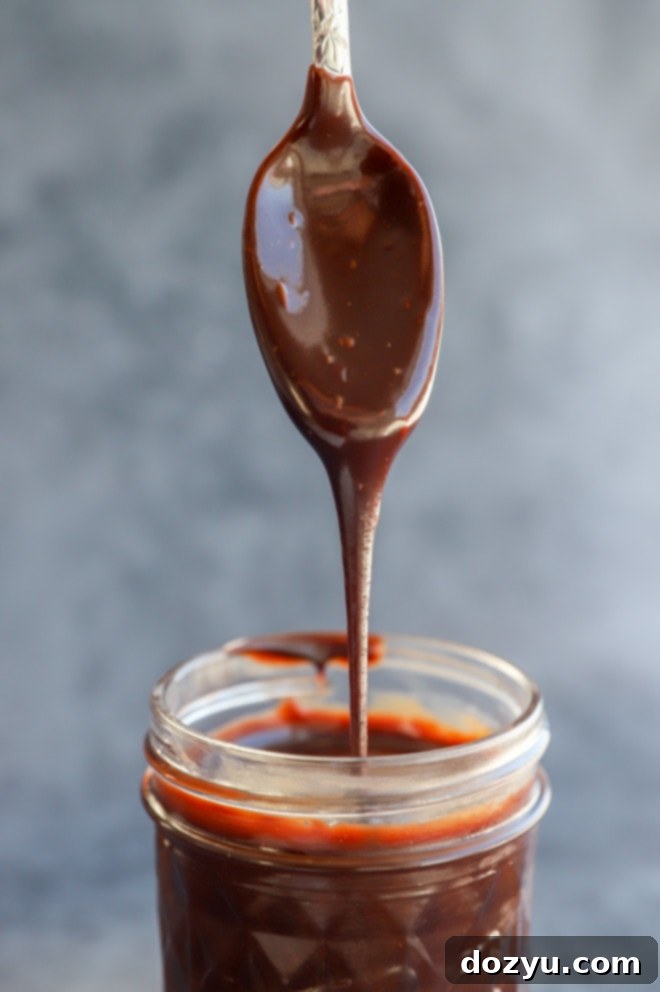 drizzling chocolate sauce into a jar image