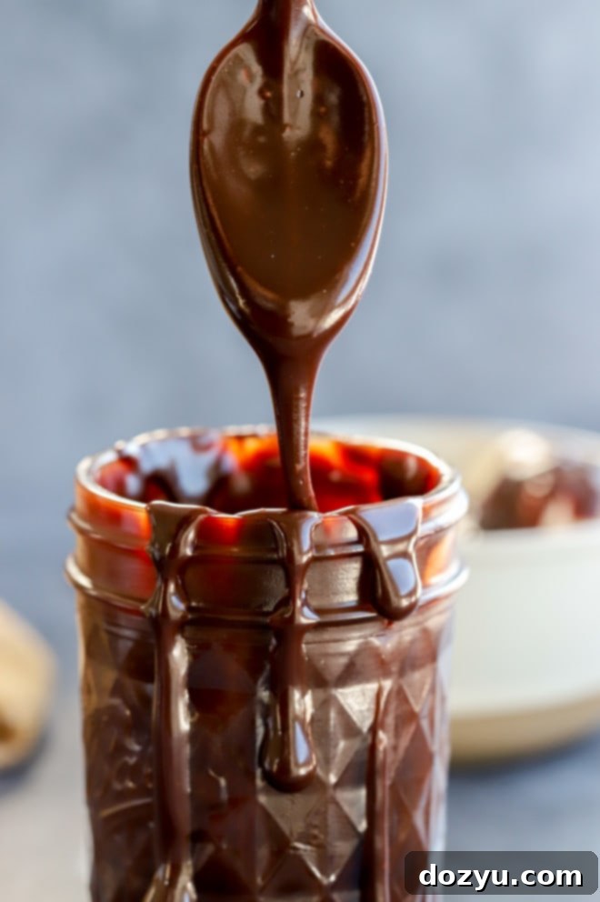 Spoon of hot fudge sauce with baileys image