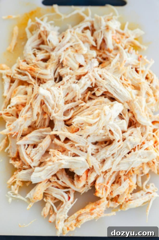 shredded chicken on a cutting board