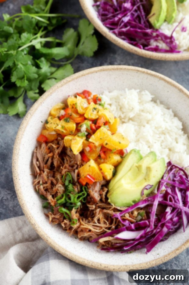 Sweet and Tangy Teriyaki Pulled Pork Bowls with Mandarin Salsa 4 Overhead image of three colorful Instant Pot Teriyaki Pulled Pork Bowls with fresh garnishes