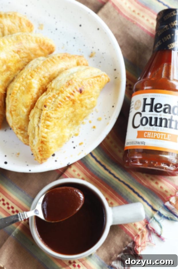 Close-up of three air fryer empanadas with BBQ sauce drizzle