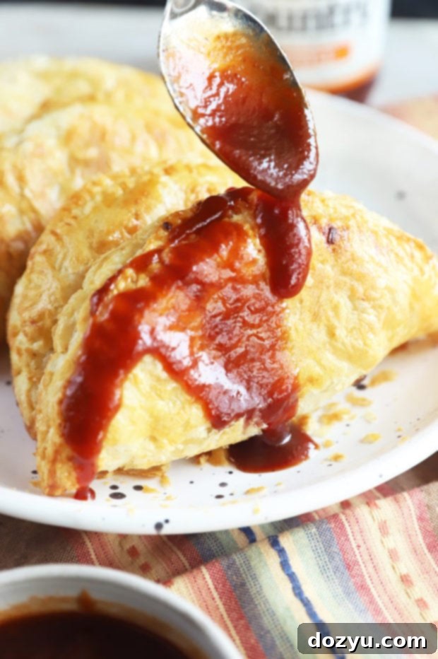 Chipotle BBQ Steak Air Fryer Empanadas with a bowl of Head Country BBQ Sauce for dipping