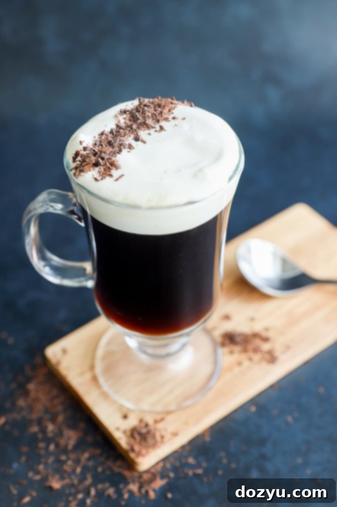 classic Irish coffee in clear mug with topping