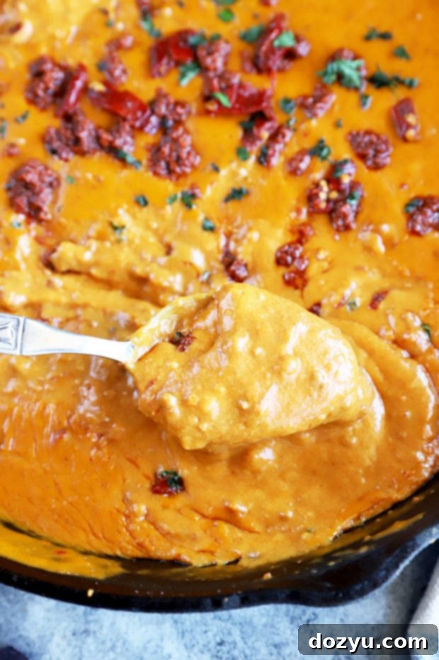 Dipping spoon in queso image