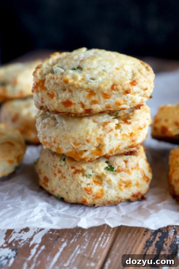 Side photo of a stack of jalapeno cheddar biscuits, perfectly golden and layered.