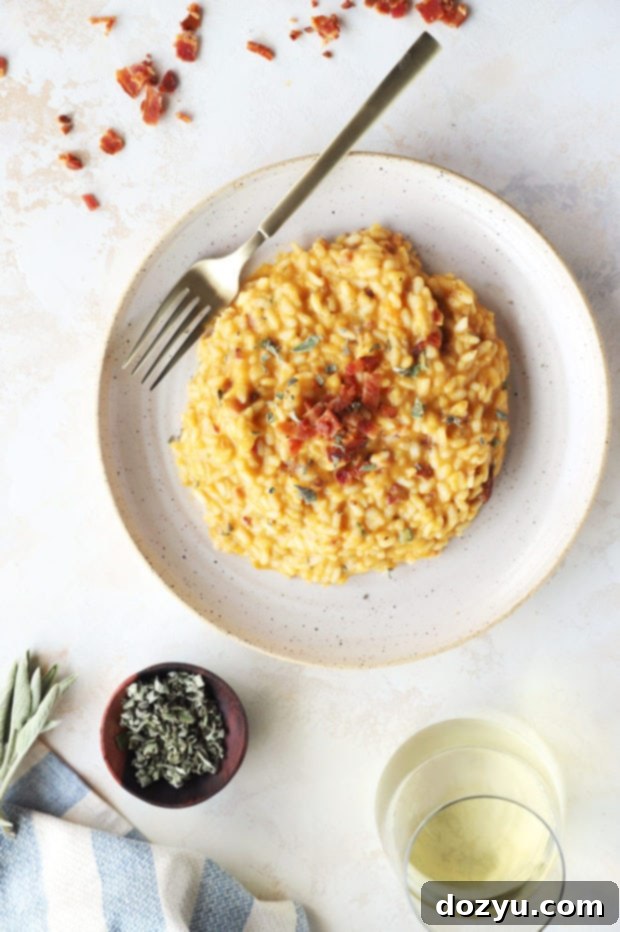 Rich and creamy Bacon Butternut Squash Risotto served in a bowl, garnished with fresh sage and bacon bits.
