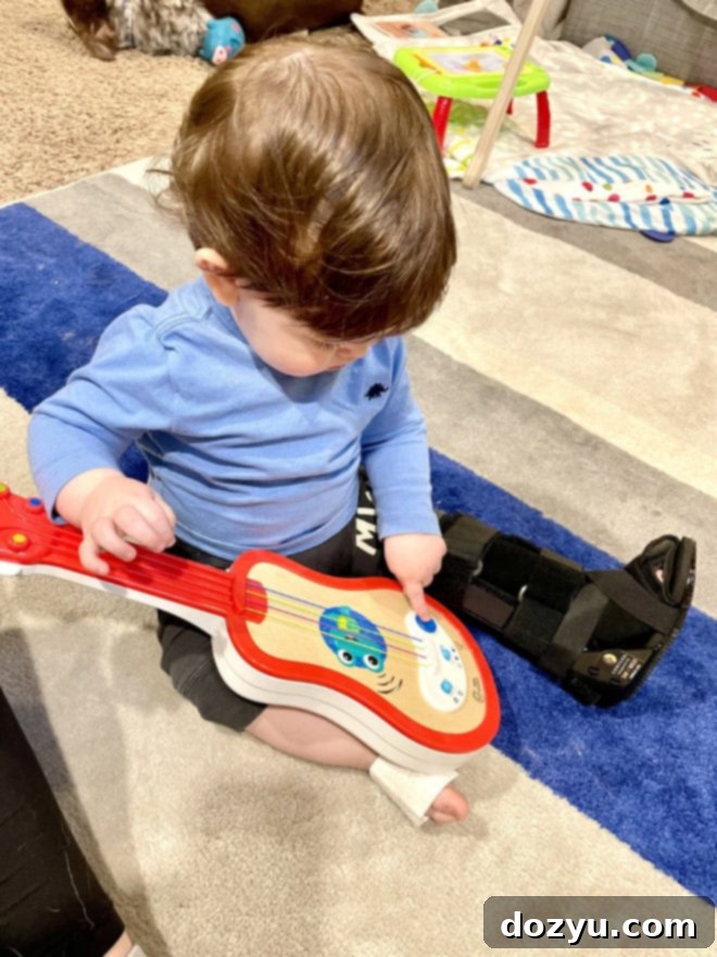 Woman holding a baby, looking at the camera with a warm smile