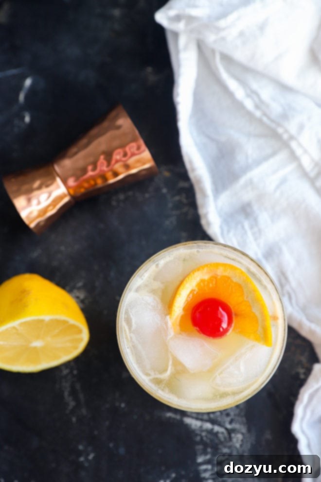 Overhead shot of a golden whiskey drink, showcasing its inviting color and the delicate ice within the glass.