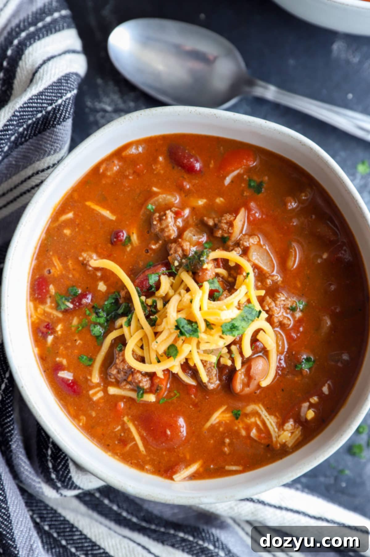 Overhead image of chili in a bowl with a spoon