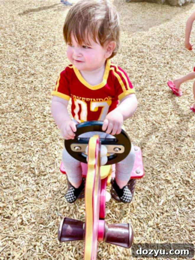Baby in April on firetruck bouncy image