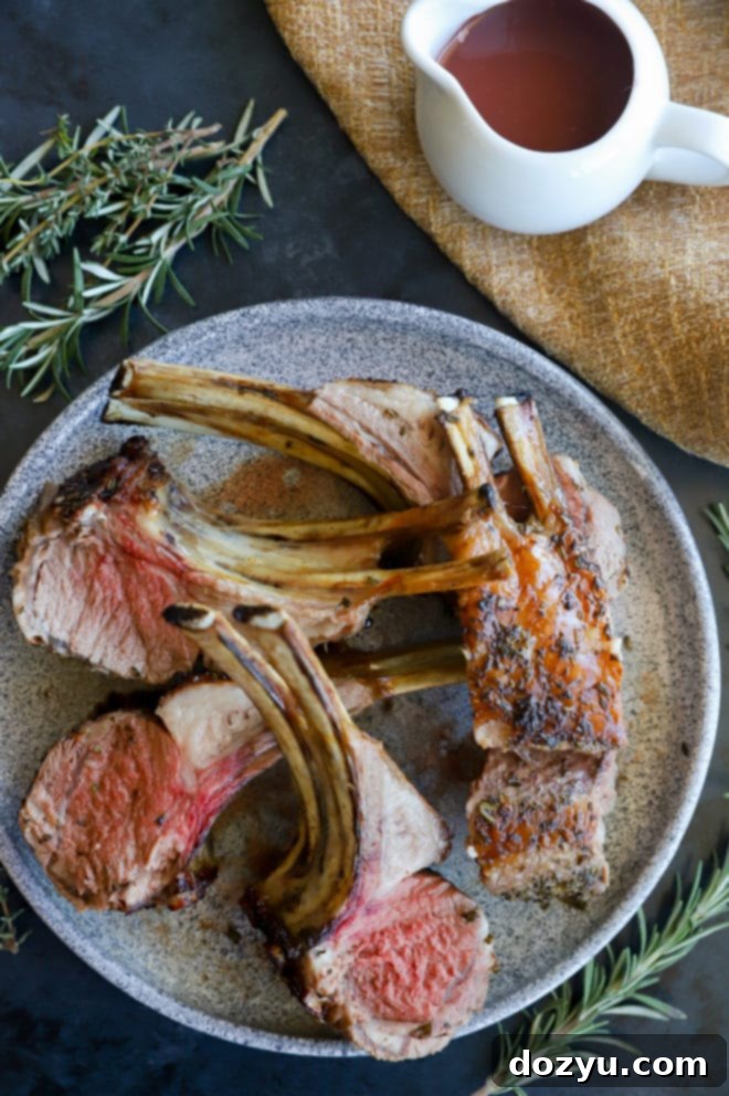 A perfectly cooked rack of lamb, elegantly plated with a rich red wine jus drizzled over it, and a side of fresh herbs.
