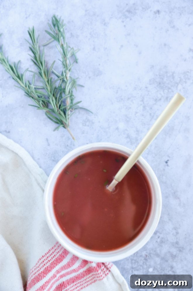 An overhead shot showcasing a bowl of luscious Red Wine Jus, perfectly thick and glossy, ready for pairing.