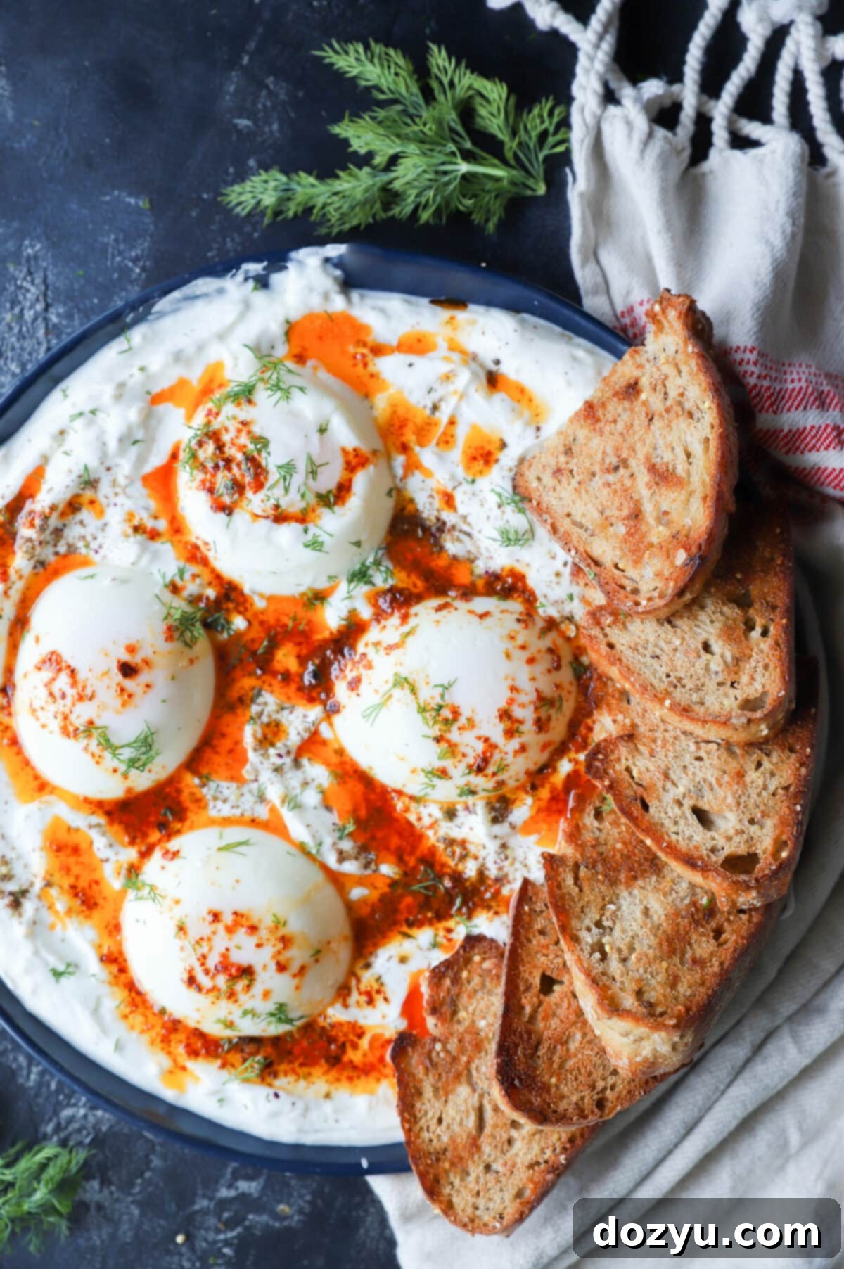Overhead image of poached eggs platter with yogurt and butter