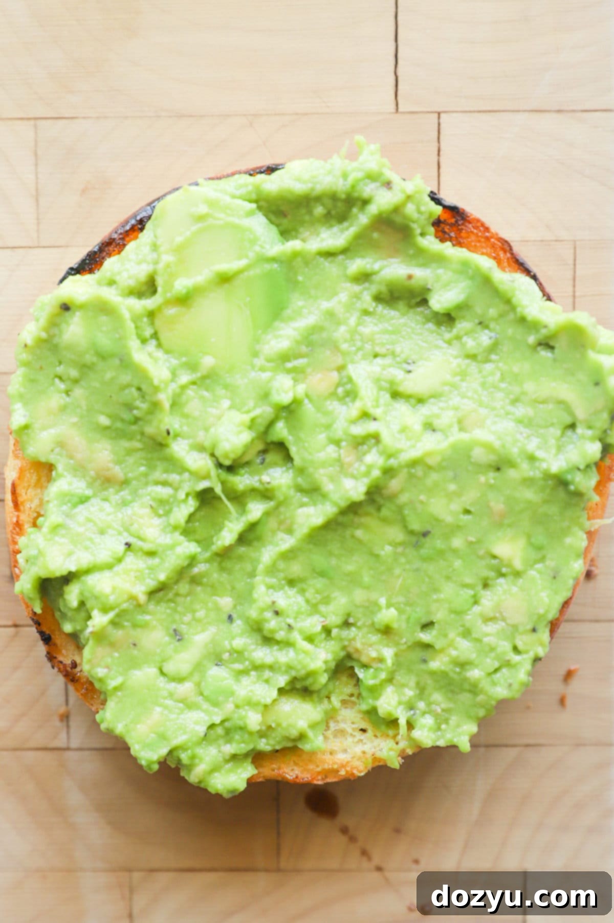 Bun with mashed avocado on top picture