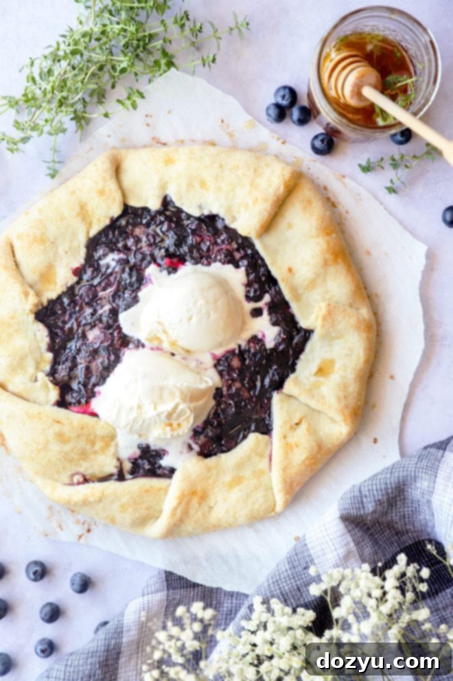 Easy blueberry galette with a scoop of vanilla ice cream