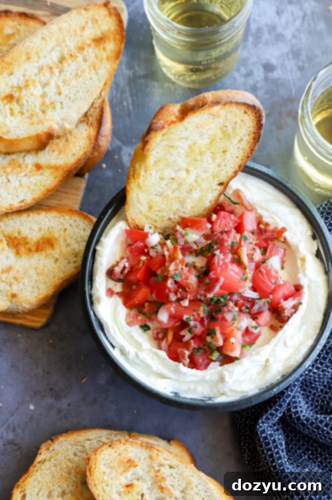 A bowl overflowing with whipped goat cheese salsa dip, surrounded by toasted bread slices, ready to be enjoyed