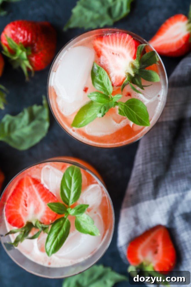 Closeup of a Strawberry Basil Margarita with ice and garnish