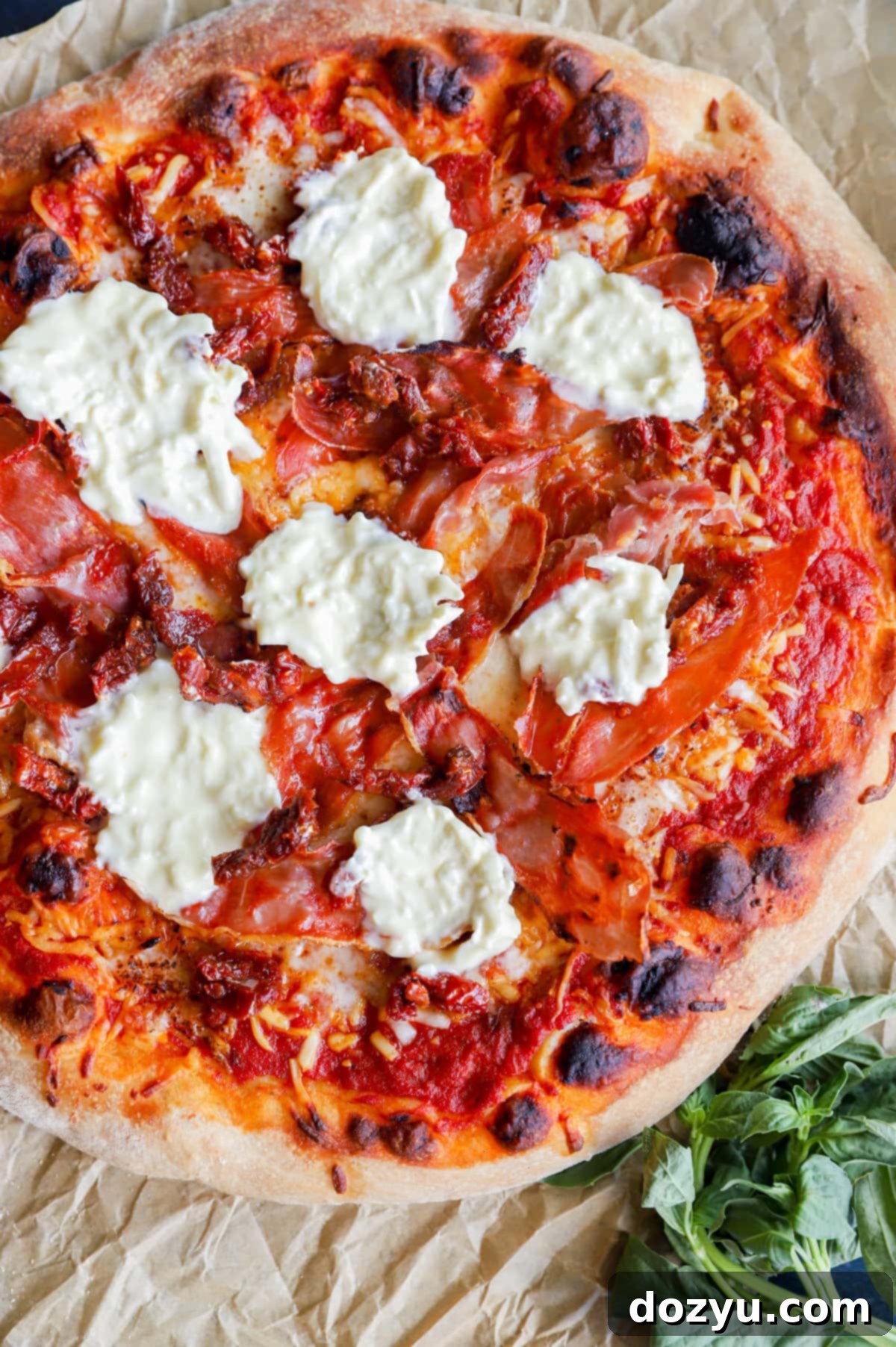 Topping pizza with burrata cheese after grilling