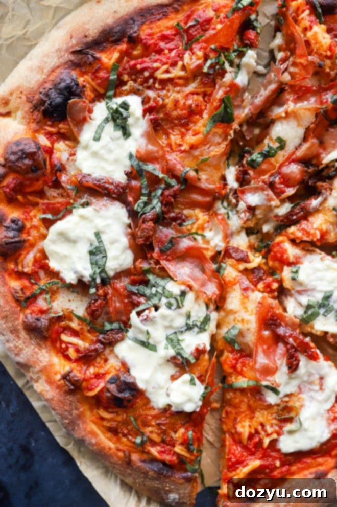 Final image of grilled pizza with fresh basil and burrata