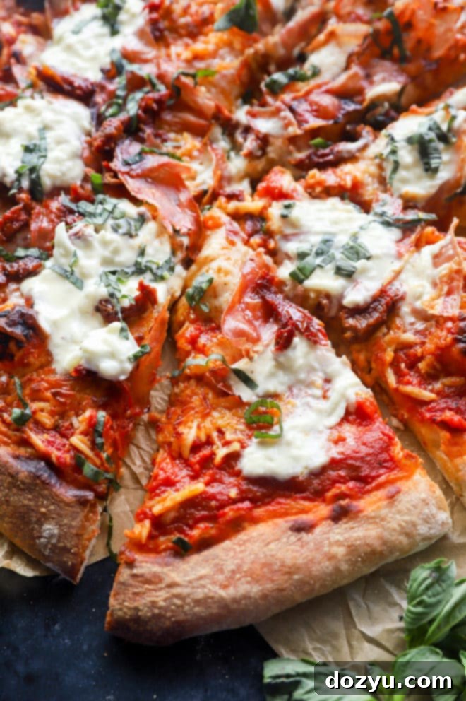 Slices of grilled burrata pizza with fresh basil and crispy prosciutto