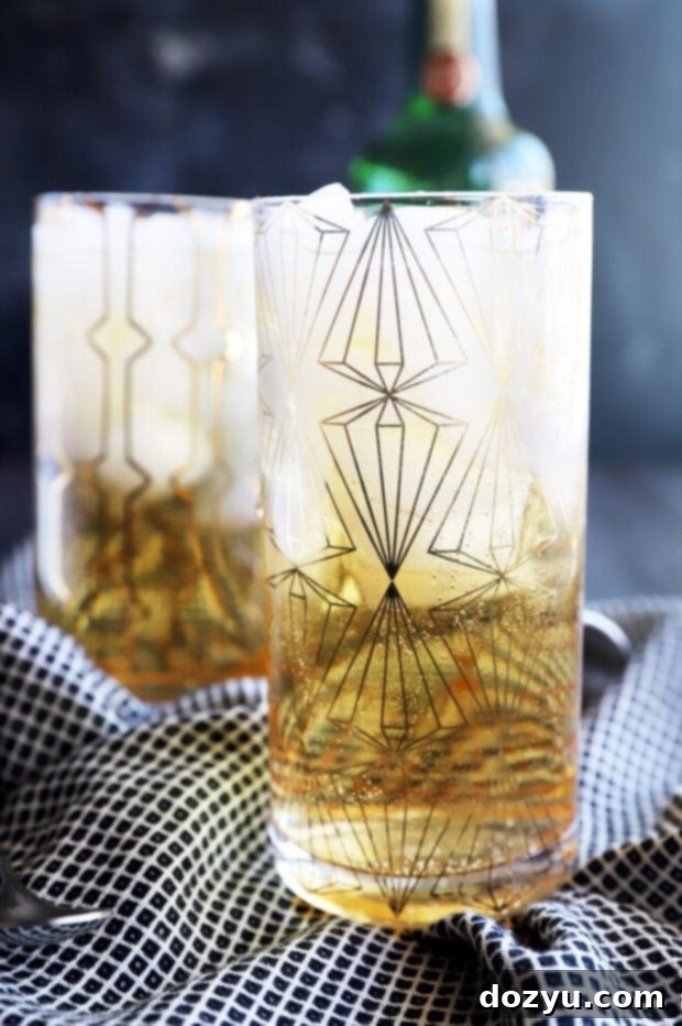 A perfectly chilled Jameson and Ginger cocktail in a highball glass, garnished with a fresh lime wedge.