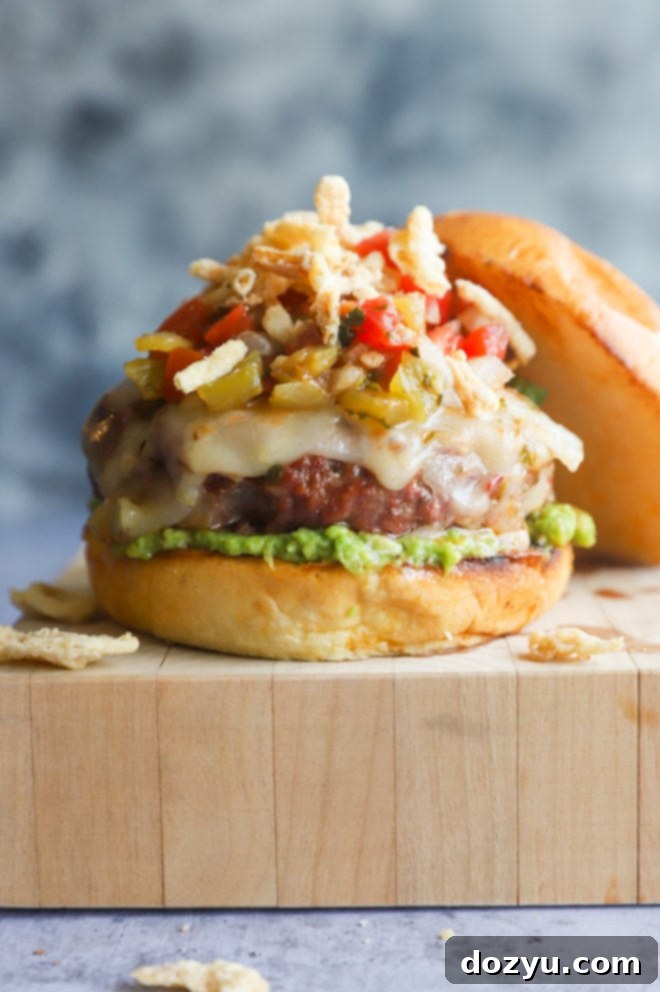 A Salsa Jalapeño Crunch Burger served on a butcher block, showcasing its crispy toppings and vibrant ingredients.