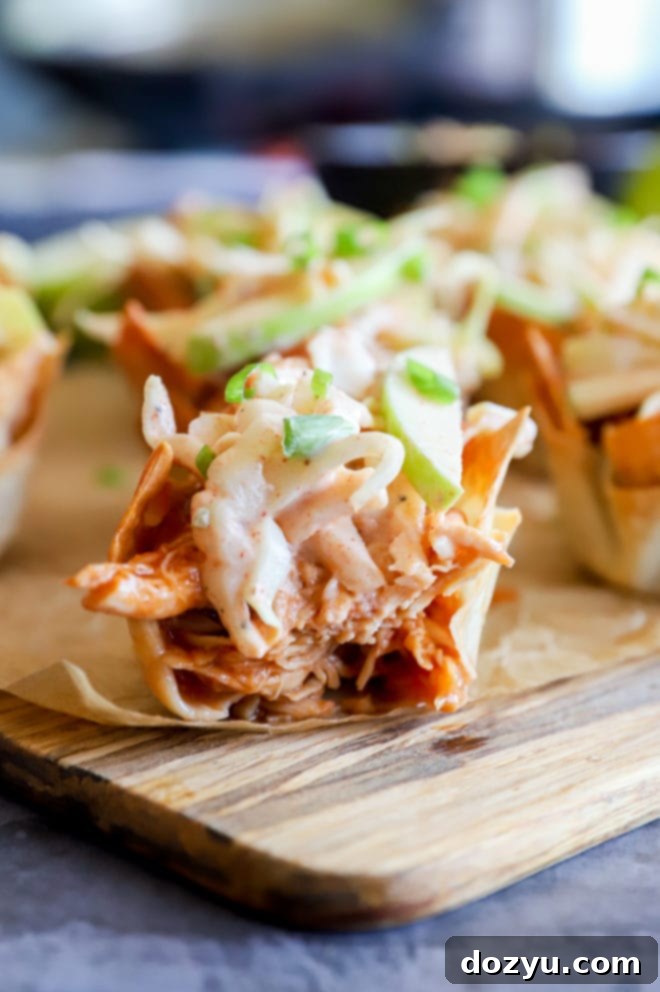 A close-up shot of several Spicy BBQ Chicken Wonton Cups arranged neatly, highlighting the crispy wontons.