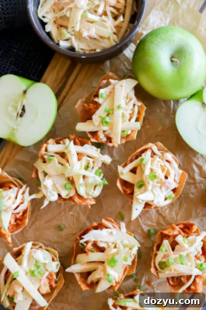 A serving of Spicy BBQ Chicken Wonton Cups on a plate, garnished with green onions and ready for a party.