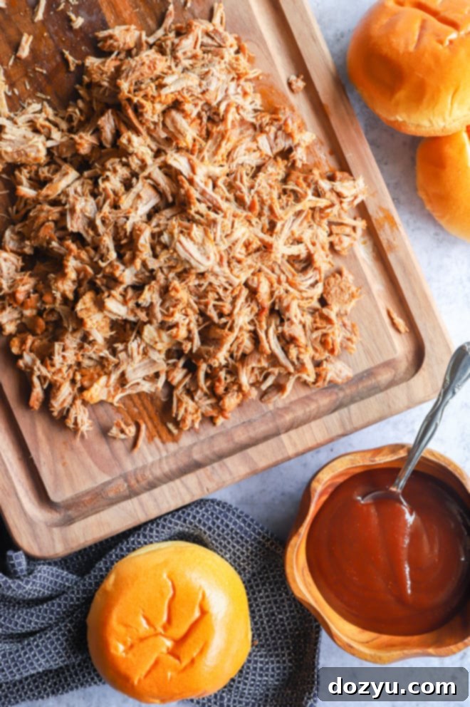 Tender Instant Pot Pulled Pork on a cutting board, ready to be shredded