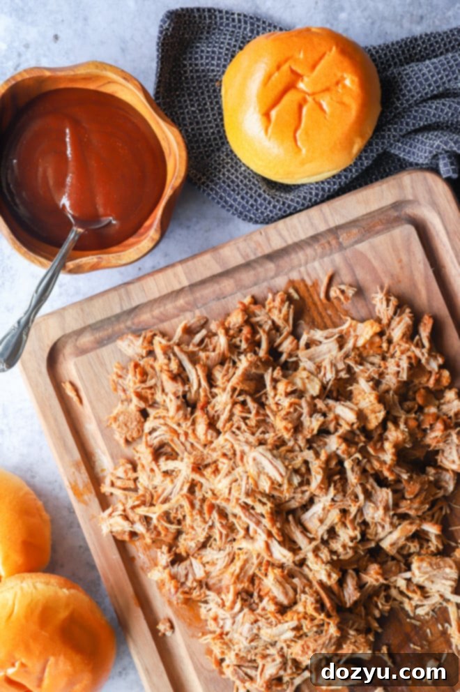 Close-up of Instant Pot pulled pork with BBQ sauce and brioche buns