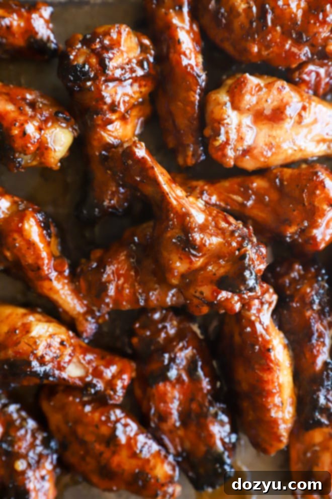 Blazing Honey Bourbon Wings 2 Image of chicken on a sheet pan, perfectly grilled and glistening with sauce