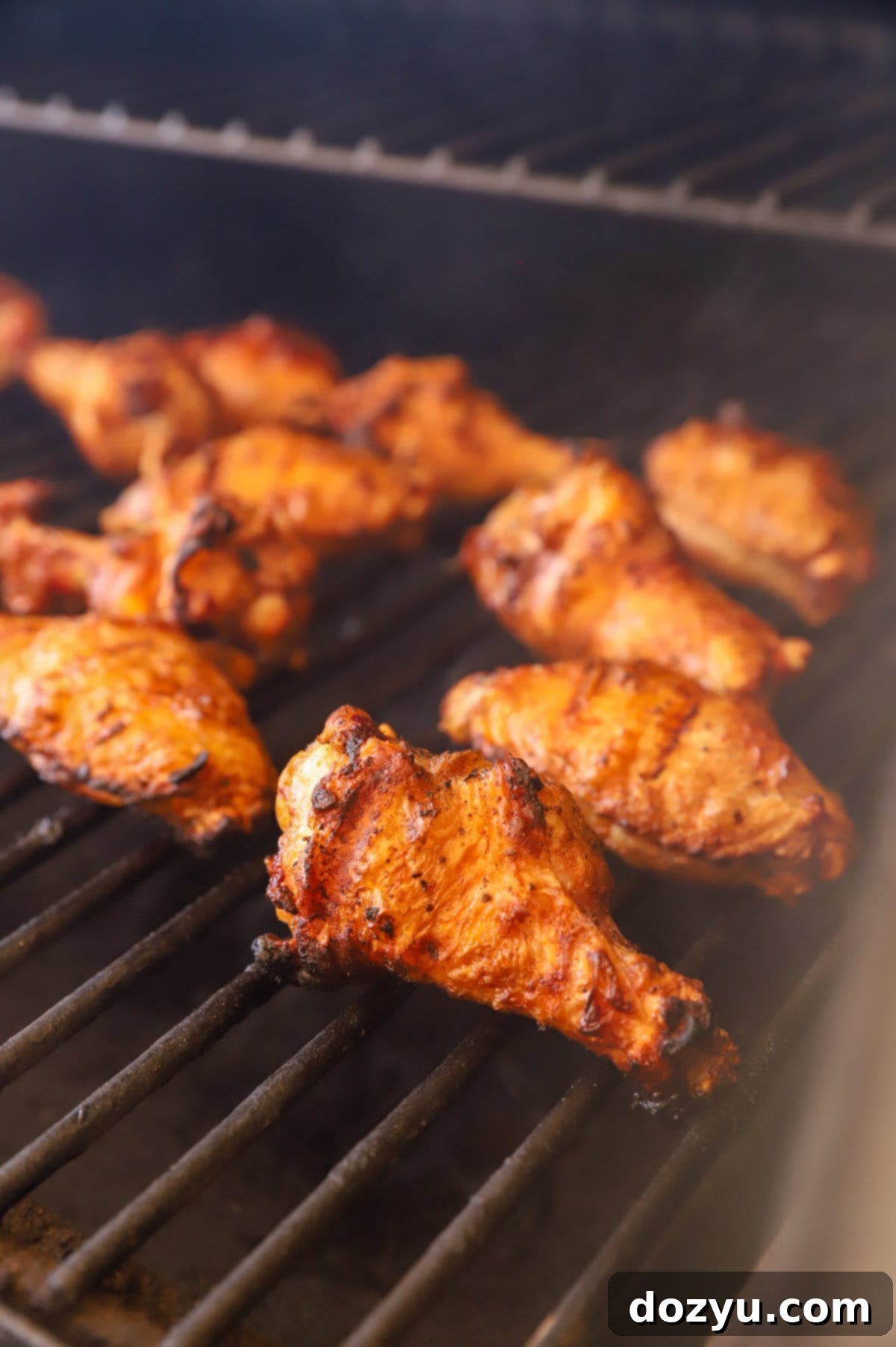 Blazing Honey Bourbon Wings 6 grilling chicken wings on a traeger image, showing the smoking process