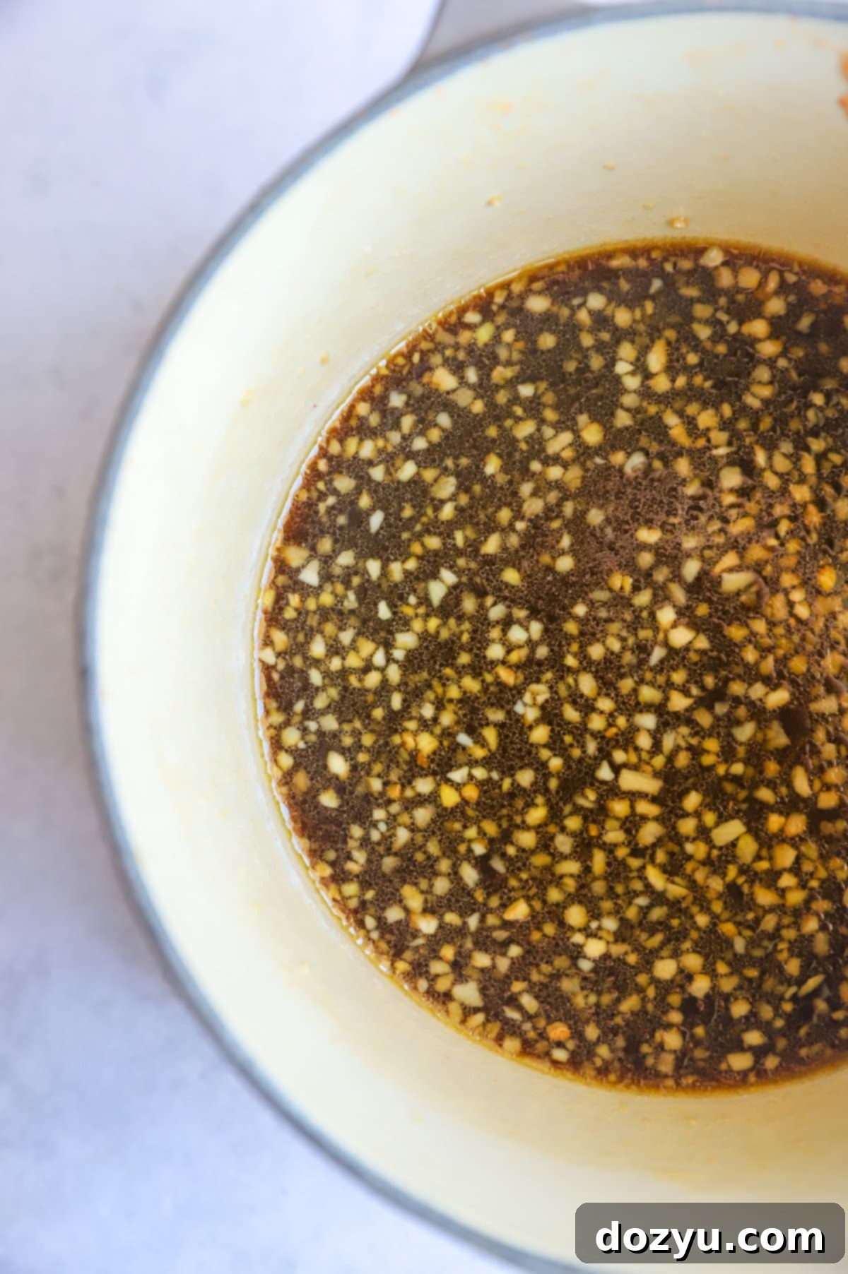 Blazing Honey Bourbon Wings 7 hot honey whiskey sauce in a saucepan image, simmering to perfection