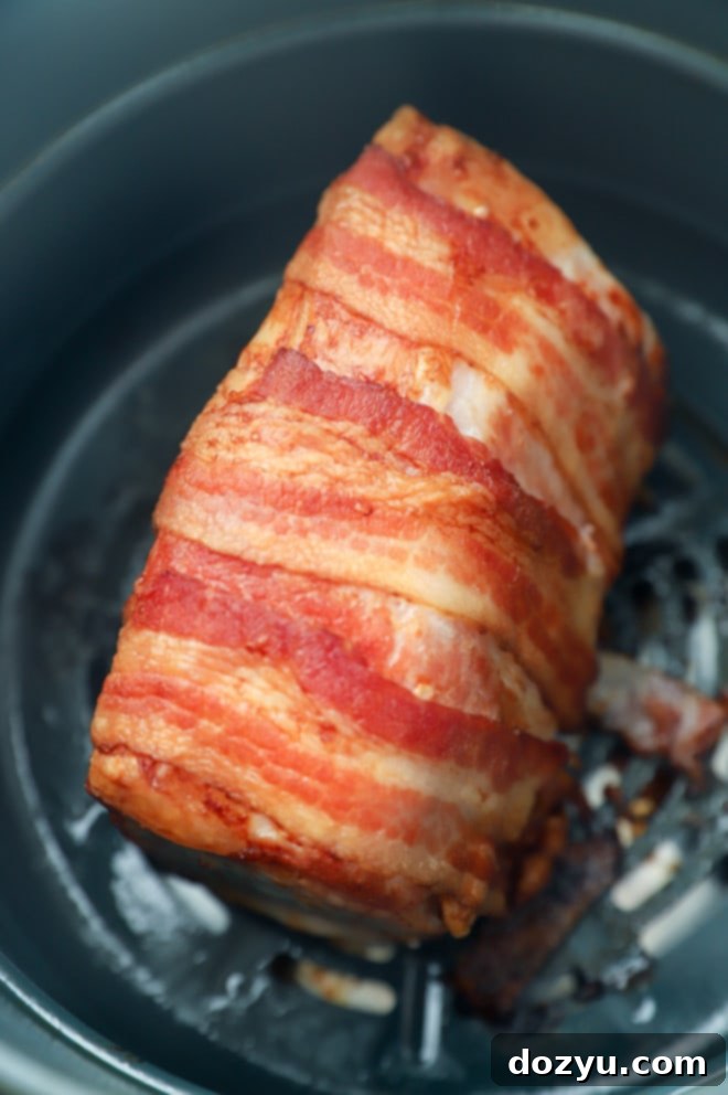 Air-Fried Bacon-Wrapped Pork Loin Perfection 8 Cooked air fryer pork loin in basket