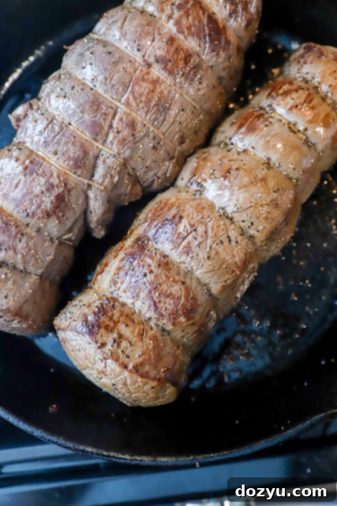 beef tenderloin in cast iron skillet image