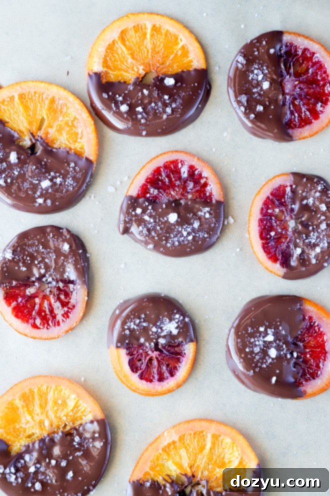 Overhead picture of candied orange slices dipped in chocolate with flaky salt