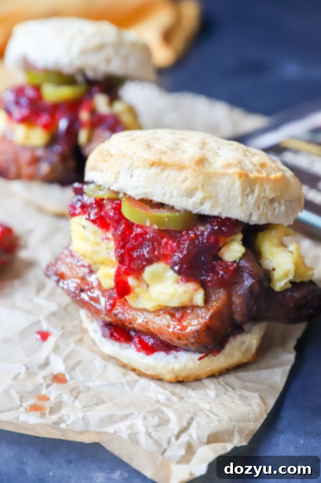 The Pork Belly Breakfast Sandwich, sliced in half to show all the delicious layers inside.