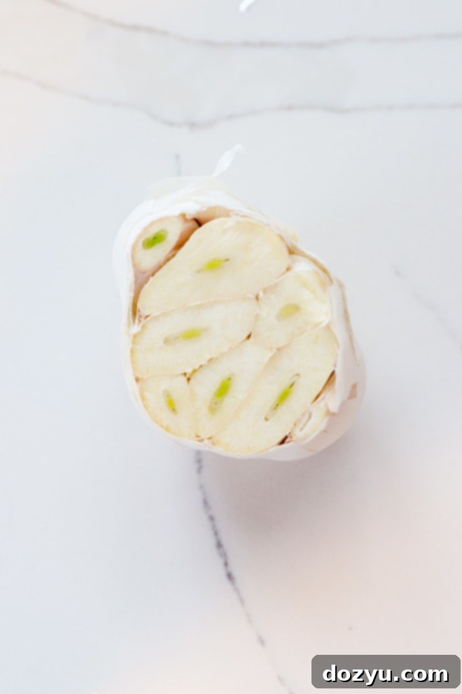 Garlic bulb with the top carefully cut off, exposing the cloves.