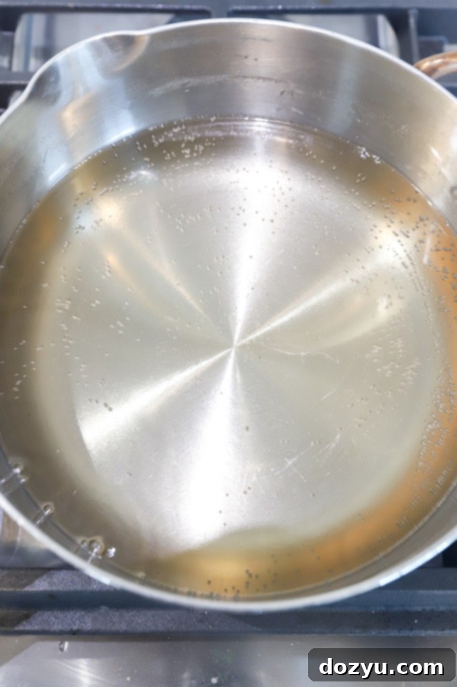 Simmering sugar syrup in a saucepan picture