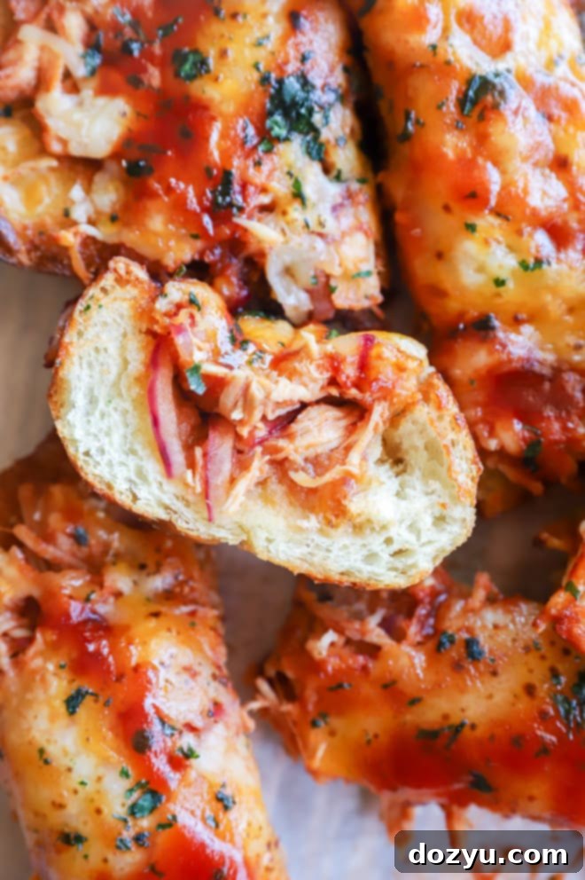 Golden brown cheesy BBQ chicken bread, freshly baked and sliced, ready to be served as a game day snack.