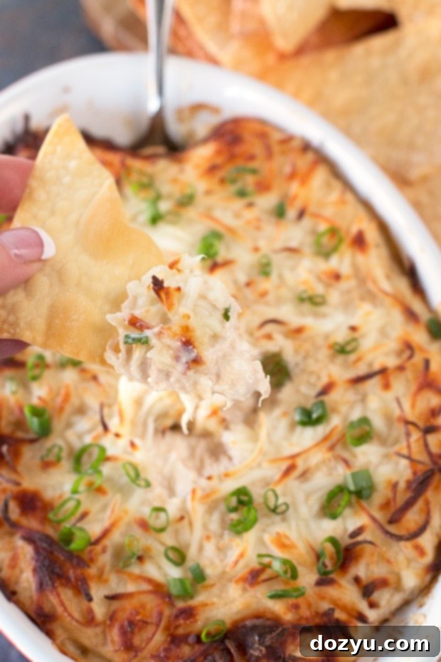 Rich and creamy Crab Rangoon Dip served with crispy fried won ton chips, a perfect appetizer for sharing.